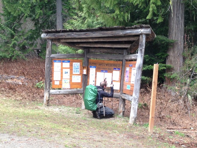 Bobby reading the trail informational signage at the trailhead
