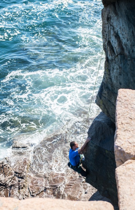 A climber working his way up a route on the Otter Cliffs