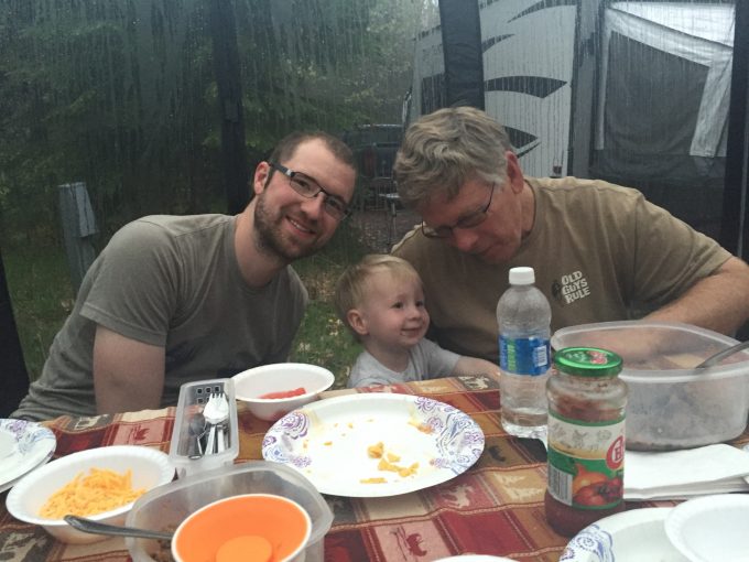 Bobby, Jack, and Grandpa enjoying the adventure of eating in the rain!