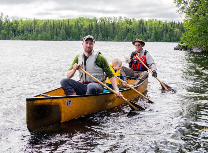 Grandpa, son, and grandson in canoeing in the BWCA