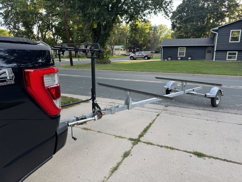 Two-canoe rental trailer attached to a pickup truck